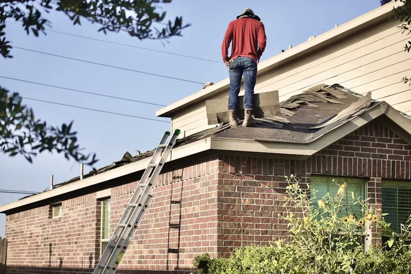 Professional roofer working on a residential roof in Stedman